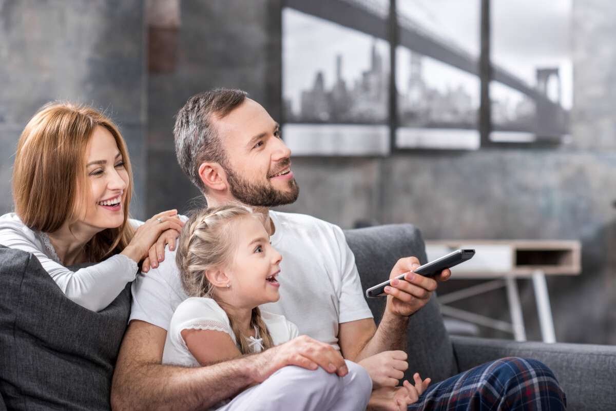 happy-family-sitting-on-sofa-and-watching-tv-toget-2021-08-29-1_p49202